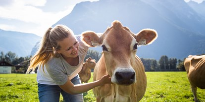 Händler - überwiegend regionale Produkte - Ebenau - Landwirtin und Pädagogin Maria mit Kuh Sonnenschein Copyright Salzburger Land - Bio Hofkäserei Fürstenhof