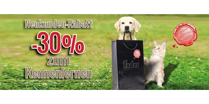 Händler - Großwilfersdorf - Das Bild zeigt eine Katze und einen kleinen Hund neben mit einer Fedor® Tragetasche sitzend. Daneben steht „Neukunden-Rabatt -30% zum Kennenlernen!“ geschrieben. - Fedor® Tiernahrung